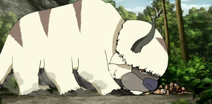 Appa fills the frame as the rest of the Aang Gang lies on the ground under his mouth to the right