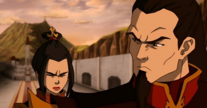 Azula hangs her head as Ozai looks down at her dismissively, they are standing in front of a mountain and slate wall
