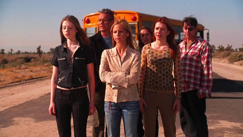 From left to right: Dawn, Giles, Buffy, Faith, Willow, and Xander stand at the cusp of Sunnydale in the show's finale.
