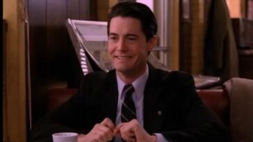 Dale Cooper grins in a booth at the Double R while thinking about Annie.