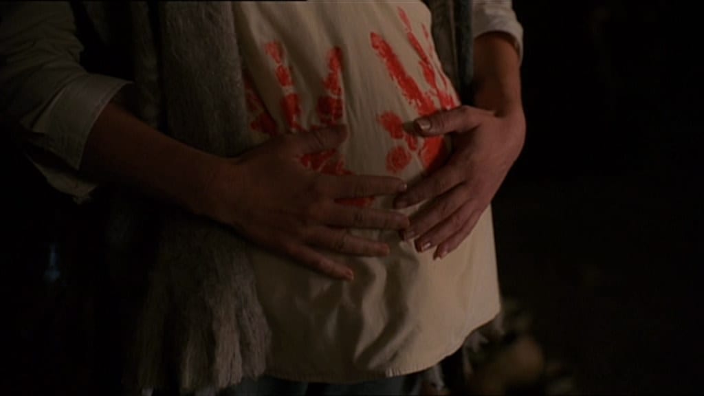 Darla's pregnant body with bloodied handprints on her shirt.