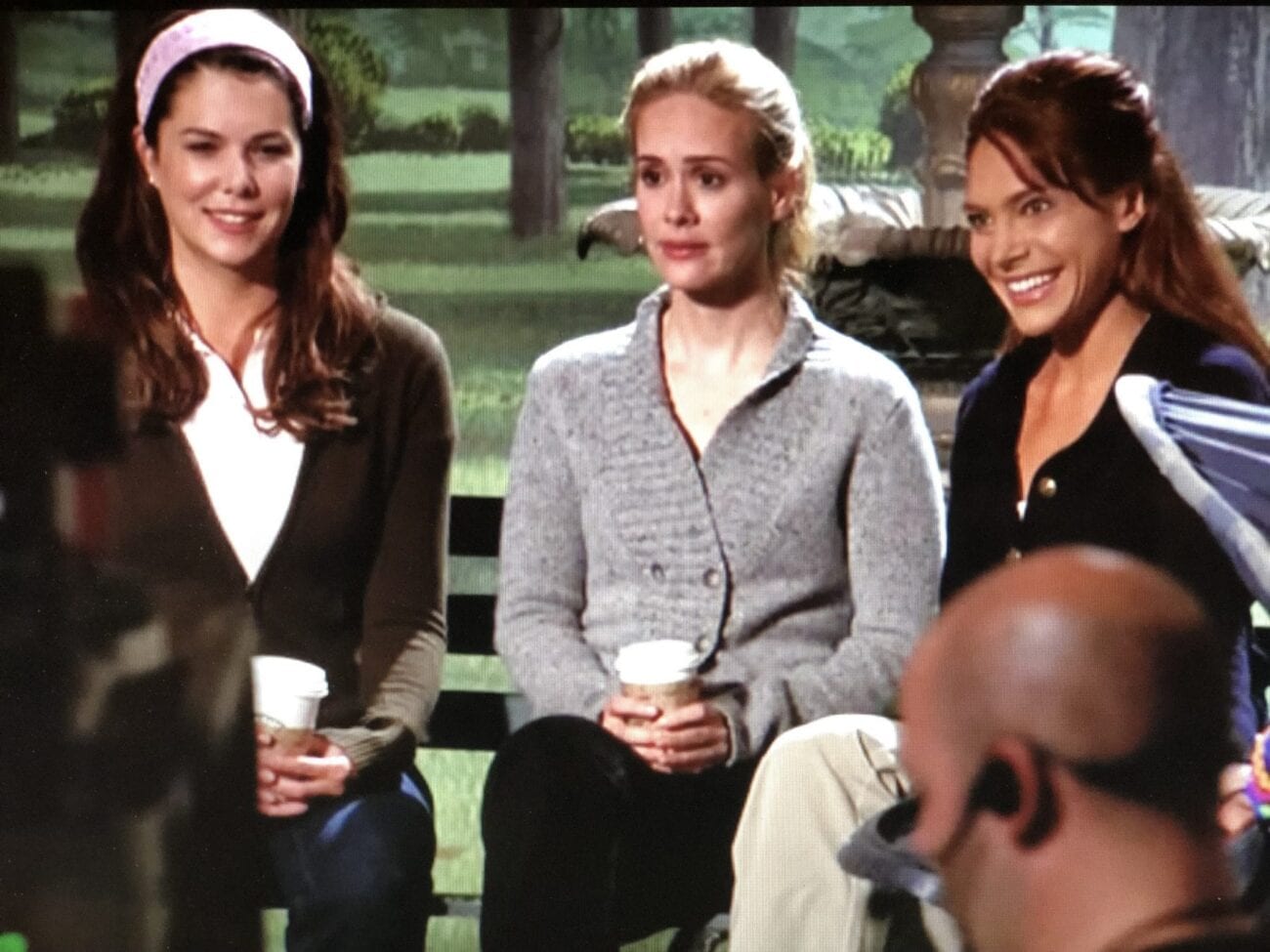 Lauren Graham, Harriet, and Jeannie sit on a park bench, during a sketch