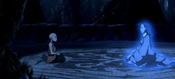 Aang sits to the left and speaks with Yangchen, who appears glowing blue to the right
