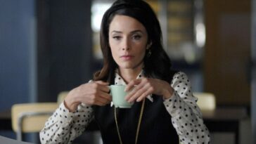 Lucy holds a cup of tea in Timeless