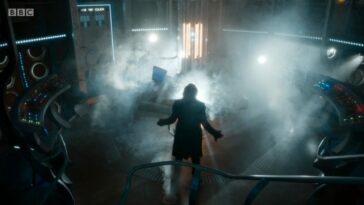 A silhouette of the newly regenerated Thirteenth Doctor in the TARDIS, lights glaring