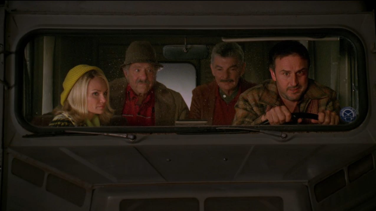 Olive (Kristen Chenoweth) is in a car with Jerry and Buster with Randy (David Arquette) driving.