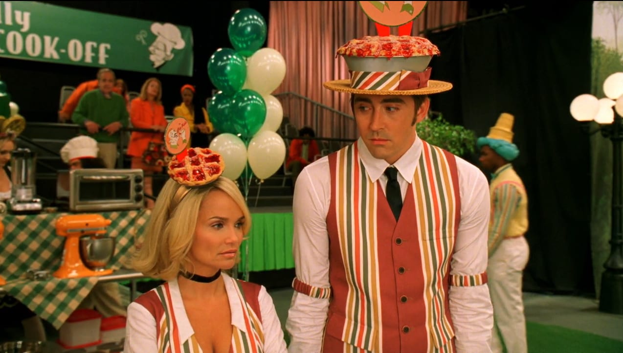 Olive (Kristen Chenoweth) talks with Ned (Lee Pace) while in pie uniforms.
