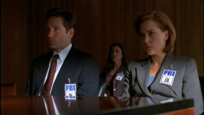 Mulder (David Duchovny) and Scully (Gillian Anderson) at an FBI tribunal...