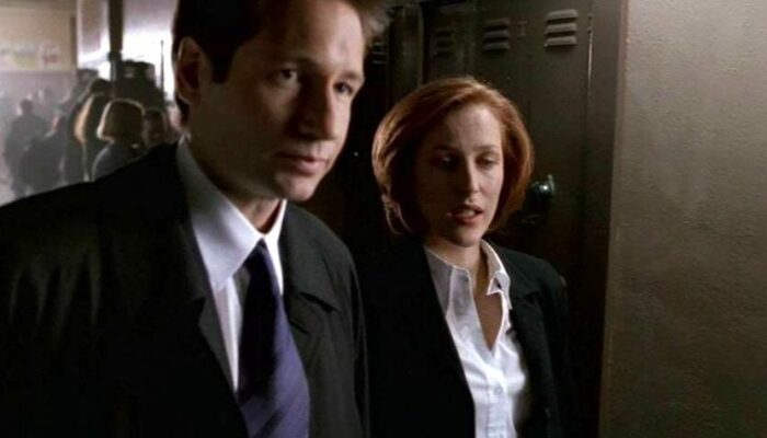 Mulder and Scully stand in a hall in front of a locker