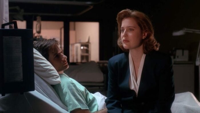 A two-shot of Mulder and Scully while Mulder is in a hospital bed in 'Beyond the Sea' (S1E13)