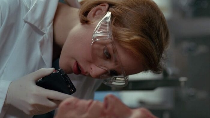 Scully talks into a tape recorder while conducting an autopsy in 'Revelations' (S3E11)