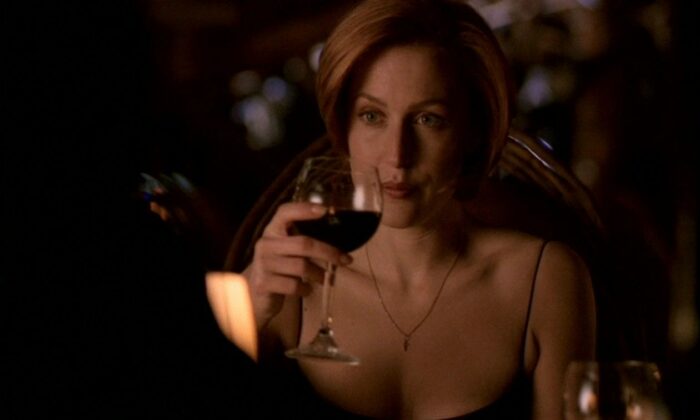 Scully drinks wine...