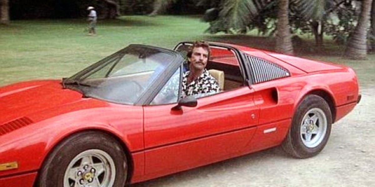 Magnum sitting in his Ferrari, smirking through the open top of the car in Magnum PI