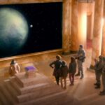 A group stands looking at planets through a window in Doctor Who Nightmare in Silver