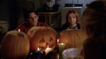 Xander and Willow sat with some pumpkins they've carved (over the shoulder shot from Buffy's POV)