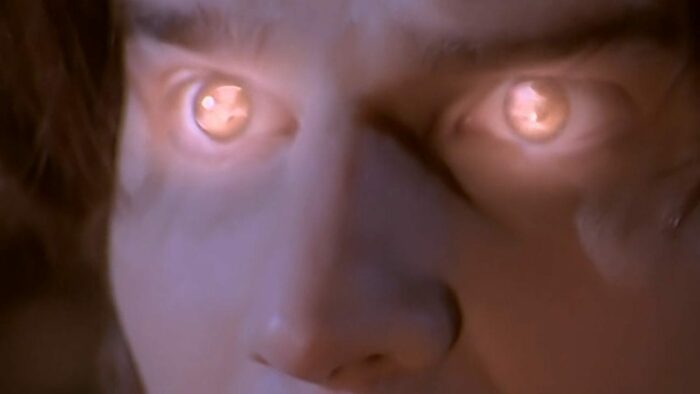 A close-up on Angel's glowing eyes as his soul is restored