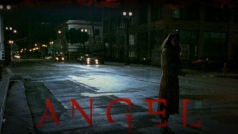 A woman stands on a street as the title of Angel appears on the bottom of the screen