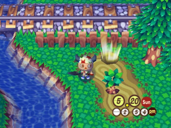 The player character stands with a shovel next to a river and a small tree in Animal Crossing on the GameCube