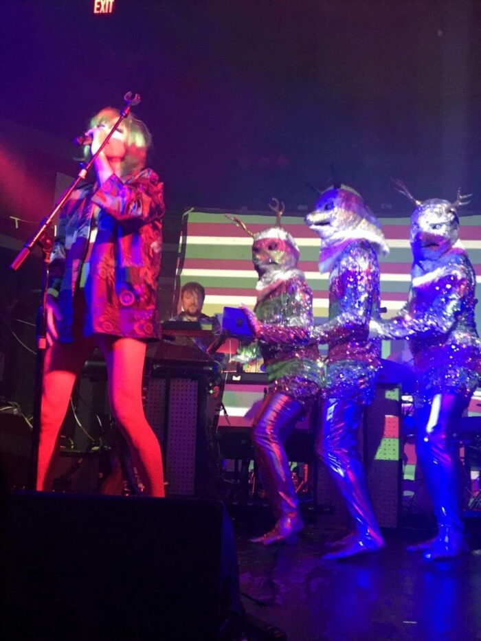 of Montreal’s Kevin Barnes onstage with people in psychedelic costumes