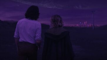 Loki (left) and Sylvie (right) and framed from behind, walking towards a purple skyline.