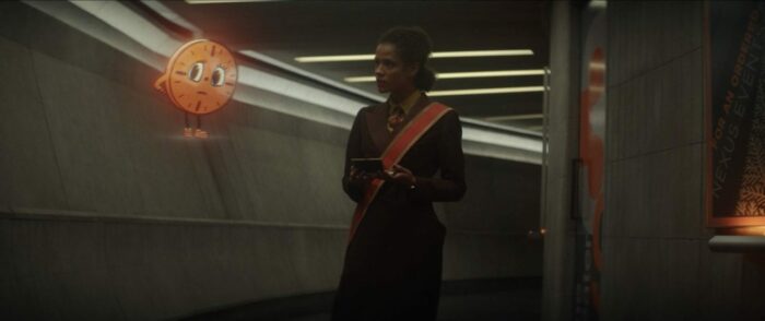 Ravonna (right) attempts to trick Miss Minutes, a small animated clock with eyes (left), to reveal information on the TVA.