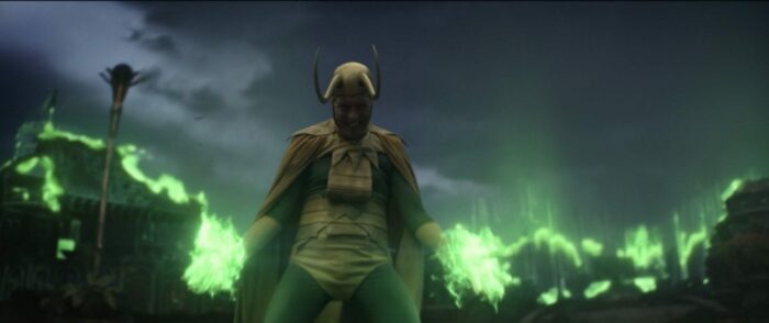 Classic Loki stands in his classic comics costume and uses his green projecting magic to create Asgard around him.