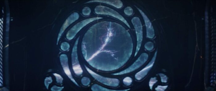The Sacred Timeline splits into the multiverse through a circular window.
