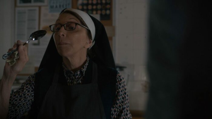 Sister Andrea examines a spoon. 