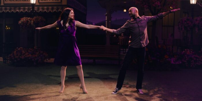 Josh (Keegan-Michael Key) and Mel (Cecily Strong) dance during in a follow spot with a darkened background