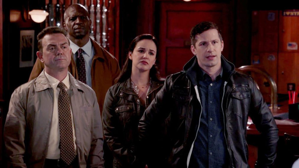 Boyle, Terry, Amy, and Jake all stand in Shaw's Bar