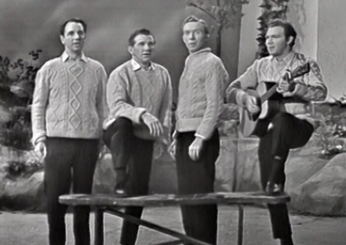Black and white image of Irish folk singers The Clancy Bros and Tommy Makem