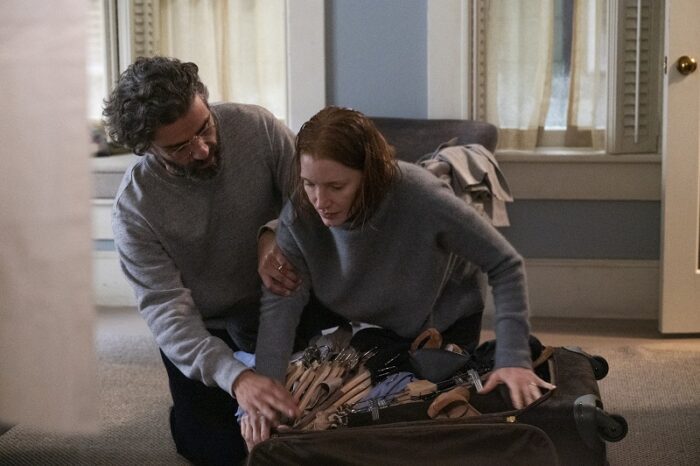In this image from Scenes from a Marriage, Jonathan (Oscar Isaac) assists Mira (Jessica Chastain) as she packs a suitcase.