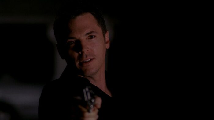 Krycek looks conflicted as he holds a gun on Mulder