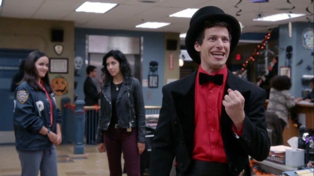 Jake rejoices in his magician's outfit while Amy and Rosa smirk in the background