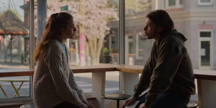 In this image from Maid, Alex (Margaret Qualley) and Sean (Nick Robinson) face each other in a coffee shop. 
