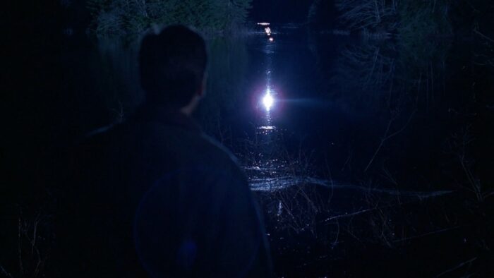 Agent Mulder looks out over a moonlit lake