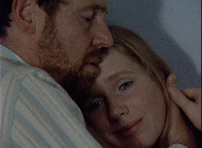 Johan (Erland Josephson) and Marianne (Liv Ullman) embrace in this close-up image from Bergman's Scenes from a Marriage.