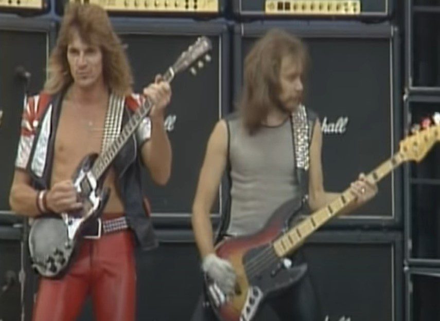 Judas Priest guitarist Glenn Tipton performing alongside bassist Ian Hill