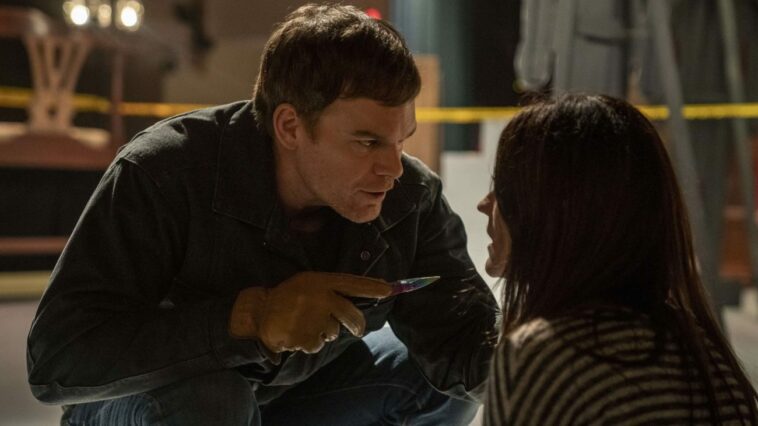 Dexter leans forward with a knife, looking at Deb