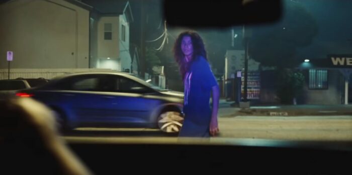 Rue's face is lit by police lights as she turns and looks directly into the camera in Euphoria Season Two