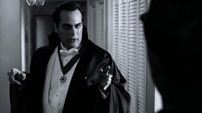 The monster as Dracula answering the door to a pizza delivery guy