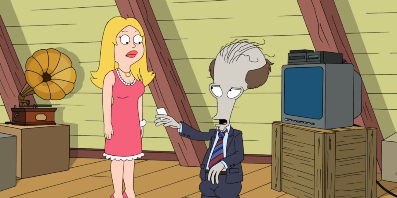 A bulbous-headed balding grey alien wears a blue suit and offers a business card to a blonde woman in a pink dress (Roger Smith as Sweeps McCullough and Francine Smith in American Dad!) 