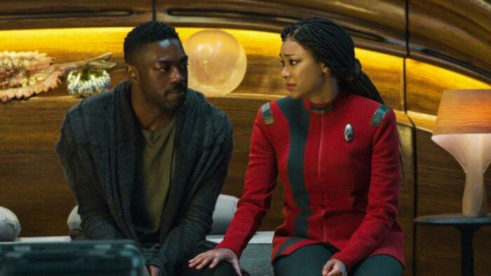 Book (David Ajala) and Burnham (Sonequa Martin-Green) sit on his bed looking at each other
