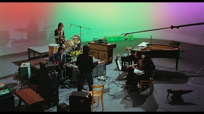 Image from The Beatles: Get Back: The Beatles rehearse "Get Back" at Twickenham Film Studios.
