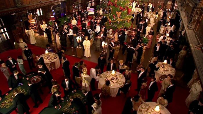Bird's eye shot of the main function room with everyone partying on the Titanic in 'Voyage of the Damned'