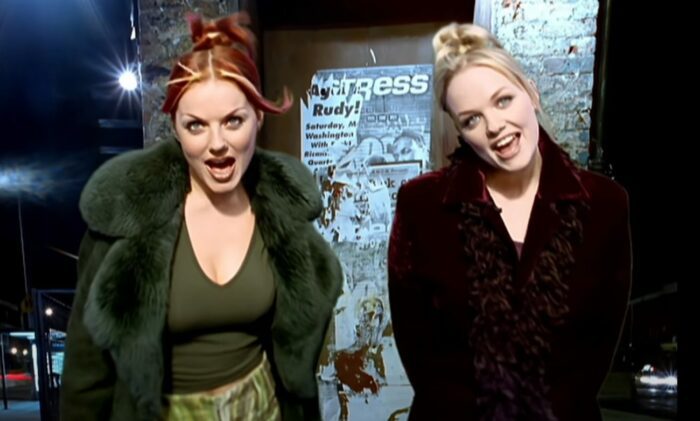 Geri Halliwell and Emma Bunton singing in the music video for 2 Become 1 