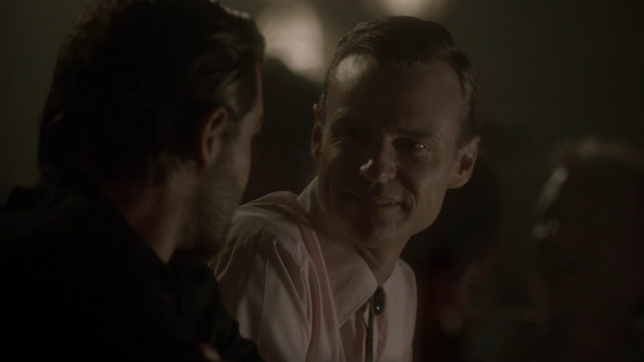 Chris smiles kindly at Brian Shafe in a flashback to the gay bar