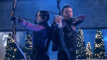 Clint and Kate, each wielding a bow with Christmas trees in the background