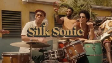 The cover of An Evening with Silk Sonic features the group