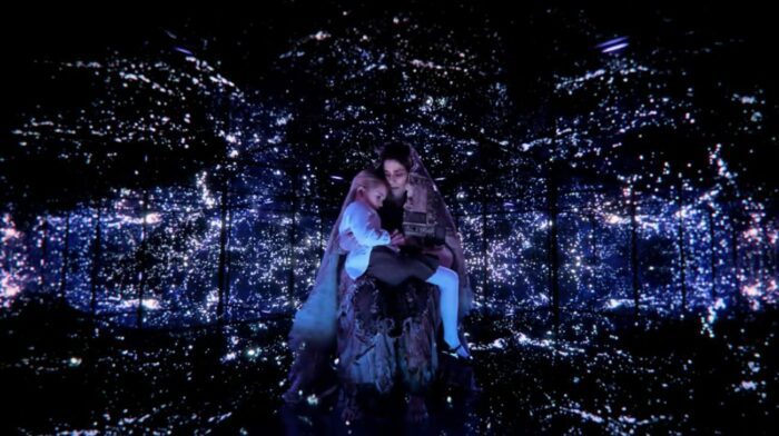 Khatun (Hiam Abbess) cradling young Nina (Zoey Todorovsky) against a backdrop of stars.